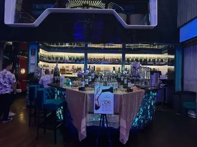 a bar in a restaurant with people sitting at it at PLATINUM Suites KLCC By AR Hospitality in Kuala Lumpur