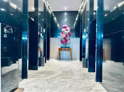 a hallway with a large bouquet of pink flowers at PLATINUM Suites KLCC By AR Hospitality in Kuala Lumpur