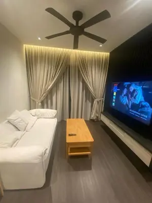 a living room with a white couch and a flat screen tv at Datum Jelatek - KLCC Sky Ring Linked To LRT & Mall by AwNa in Kuala Lumpur
