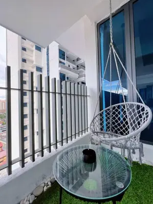 a black cat sitting on a glass table on a balcony at 2BR, 7PX The Colony@Near Quill CityMall & Monorail in Kuala Lumpur