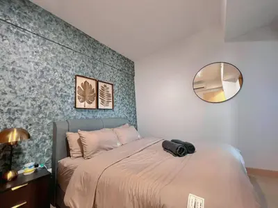 a bedroom with a bed with a round mirror at 2BR, 7PX The Colony@Near Quill CityMall & Monorail in Kuala Lumpur