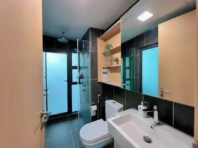 a bathroom with a toilet and a sink and a mirror at 2BR, 7PX The Colony@Near Quill CityMall & Monorail in Kuala Lumpur