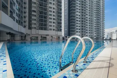 a large swimming pool with two tall buildings at RC Residences @ Sungai Besi Homestay by Birdy Stay in Kuala Lumpur