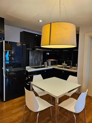 a kitchen with a white table and white chairs at Premier 2BR Suites, Dua Sentral in Kuala Lumpur