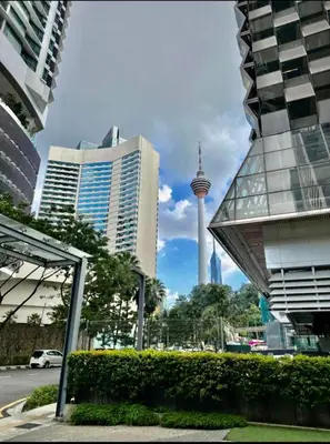 a city with a view of the space needle and buildings at Summer suites KLCC by cozy stay in Kuala Lumpur