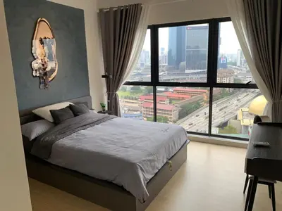 a bedroom with a bed and a large window at Continew by Plush Services in Kuala Lumpur