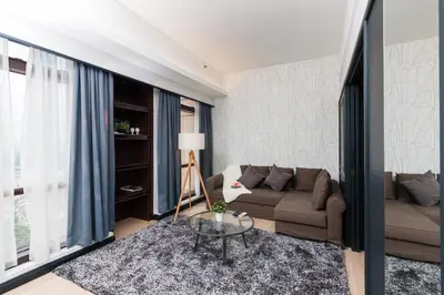 a living room with a couch and a table at Suites at TimesSquare by Plush in Kuala Lumpur