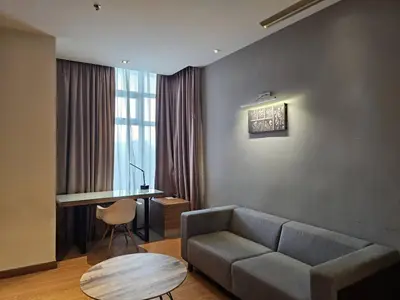a living room with a couch and a table at Deluxe Family, Dua Sentral in Kuala Lumpur