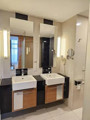 a bathroom with two sinks and a large mirror at Deluxe Family, Dua Sentral in Kuala Lumpur