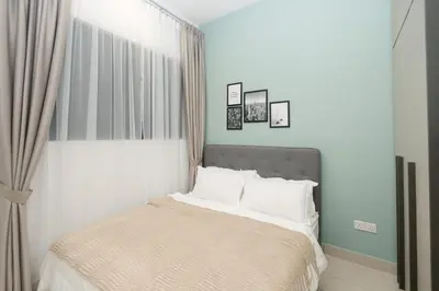 a bedroom with a bed with white pillows at Trion Kuala Lumpur by Cobnb in Kuala Lumpur