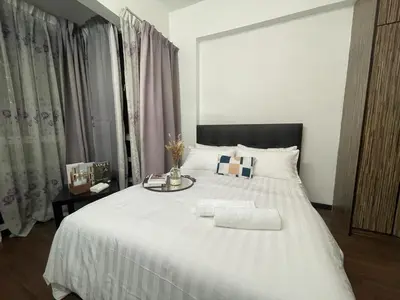 a bedroom with a large white bed with a tray on it at Villa Wangsamas By A.Golkar in Kuala Lumpur