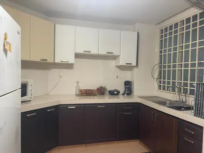 a kitchen with white cabinets and a sink at Villa Wangsamas By A.Golkar in Kuala Lumpur