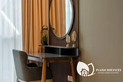 a dressing table with a mirror and a chair at Binjai 8 by Plush in Kuala Lumpur