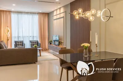 a dining room and living room with a dining table at Binjai 8 by Plush in Kuala Lumpur