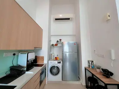 a kitchen with a refrigerator and a washing machine at 7PX 2BR Family Gathering Loft @ Colony, Near Quill City Mall & Monorail in Kuala Lumpur