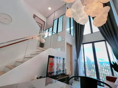 a spiral staircase in a house with a large window at 4PX Loft @ Colony, Near Quill City Mall & Monorail in Kuala Lumpur
