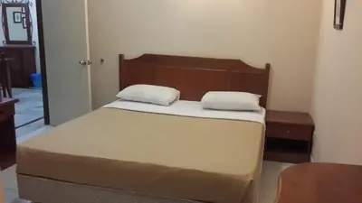 a bed with two pillows on it in a room at Golden City Apartment - Leisure Holiday Resorts in Kuala Lumpur