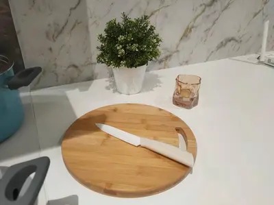 a wooden cutting board with a knife on a table at SOGO PWTC KLCC Monorail link Quill Mall 7Pax in Kuala Lumpur