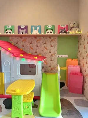 a toy kitchen with a toy stove and a microwave at Kids Friendly Kuala Lumpur Apartment in Kuala Lumpur