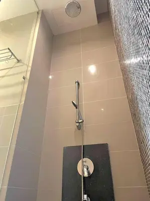a bathroom with a shower with a toilet in it at Kids Friendly Kuala Lumpur Apartment in Kuala Lumpur