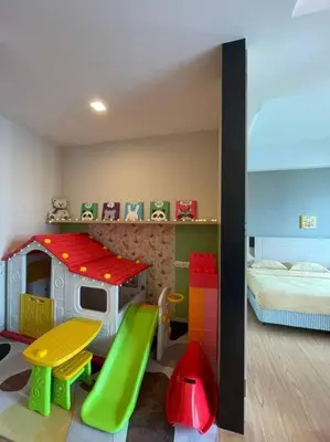 a room with a bed and a toy house at Kids Friendly Kuala Lumpur Apartment in Kuala Lumpur