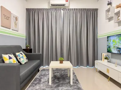 a living room with a couch and a tv at Cozy 2-bed retreat - F&B Mart - Chan Sow Lin in Kuala Lumpur
