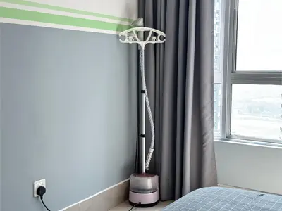 a floor lamp in a bedroom next to a window at Cozy 2-bed retreat - F&B Mart - Chan Sow Lin in Kuala Lumpur