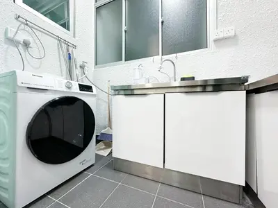 a kitchen with a washing machine and a sink at Cozy 2-bed retreat - F&B Mart - Chan Sow Lin in Kuala Lumpur
