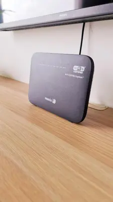 a laptop computer sitting on top of a wooden table at Mimi Cozy Homestay, 3R3B KLCC View with PLAYSTATION 4, NETFLIX, WiFi 6, Pool Table, Home Cinema in Kuala Lumpur