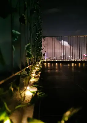a fence with a view of a city at night at Mimi Cozy Homestay, 3R3B KLCC View with PLAYSTATION 4, NETFLIX, WiFi 6, Pool Table, Home Cinema in Kuala Lumpur