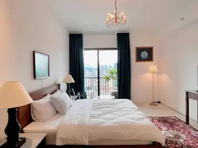 a bedroom with a bed and a large window at KLCC View with Balcony @ Chambers, KL Near LRT PWTC & Sunway Putra Mall in Kuala Lumpur
