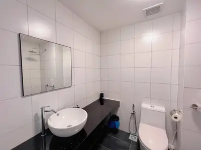 a white bathroom with a sink and a toilet at KLCC View with Balcony @ Chambers, KL Near LRT PWTC & Sunway Putra Mall in Kuala Lumpur