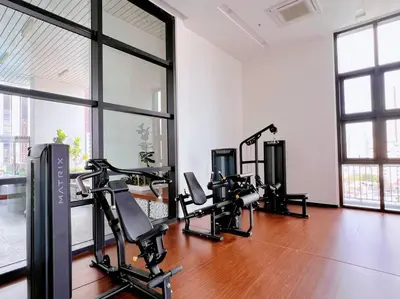 a gym with treadmills and ellipticals in a room with windows at KLCC View with Balcony @ Chambers, KL Near LRT PWTC & Sunway Putra Mall in Kuala Lumpur