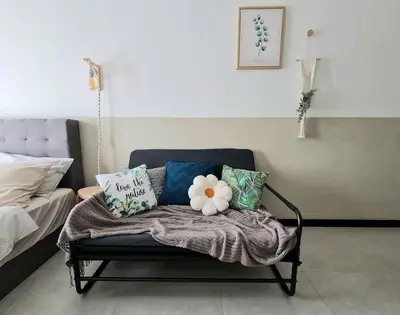 a couch with pillows on it in a room at Studio Room near Gleneagles @ Embassy Row KLCC in Kuala Lumpur