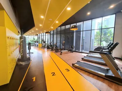 a gym with rows of treadmills in a room at Studio Room near Gleneagles @ Embassy Row KLCC in Kuala Lumpur