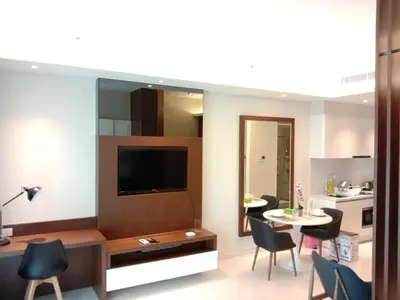 a living room with a television and a table and chairs at Tribeca Residence Bukit Bintang in Kuala Lumpur