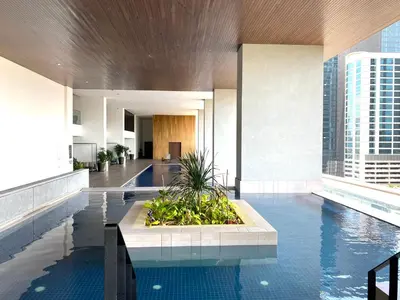 a hotel lobby with a pool in the middle of a building at The Establishment Bangsar KL by Lynhomes in Kuala Lumpur