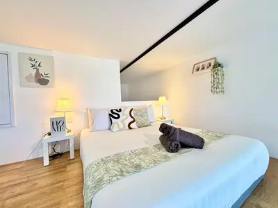 two beds in a room with white walls at The Establishment Bangsar KL by Lynhomes in Kuala Lumpur