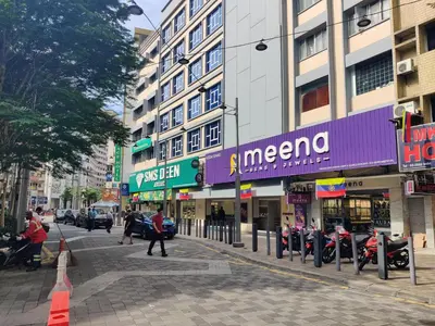 a city street with buildings and people walking on the street at Hotel WKL in Kuala Lumpur