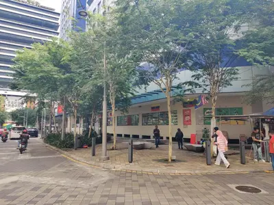 a street with trees in front of a building at Hotel WKL in Kuala Lumpur