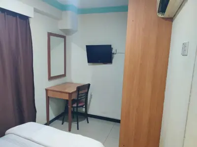 a room with a desk and a bed and a television at Hotel WKL in Kuala Lumpur