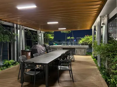 a long table and chairs on a patio with a table and chairsktop at KLCC VIEW,5 mins to KL TOWER in Kuala Lumpur