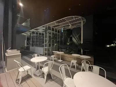 a restaurant with white tables and white chairs at KLCC VIEW,5 mins to KL TOWER in Kuala Lumpur