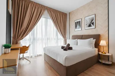a bedroom with a large bed and a large window at Colony Chow Kit Guesthouse in Kuala Lumpur