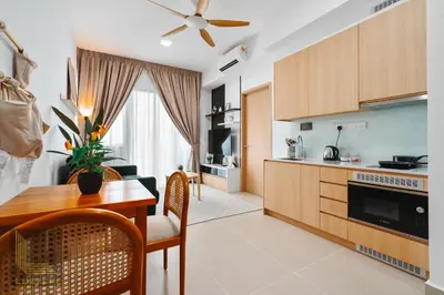 a kitchen and living room with a table and a dining room at Colony Chow Kit Guesthouse in Kuala Lumpur