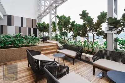 a restaurant with chairs and tables and plants at Colony Chow Kit Guesthouse in Kuala Lumpur