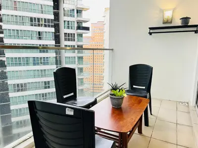 a balcony with a table and chairs and a window at Regalia Spritz Empire Hostel in Kuala Lumpur