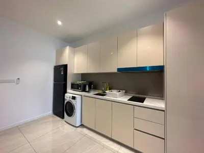 a kitchen with a refrigerator and a washer and dryer at Quill Residences KlCC By G Z in Kuala Lumpur