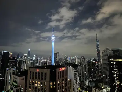 a view of a city with a blue lighted tower at Quill Residences KlCC By G Z in Kuala Lumpur