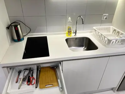 a kitchen counter with a sink and a cutting board at Chambers Residence KLCC By Purple Orchid in Kuala Lumpur
